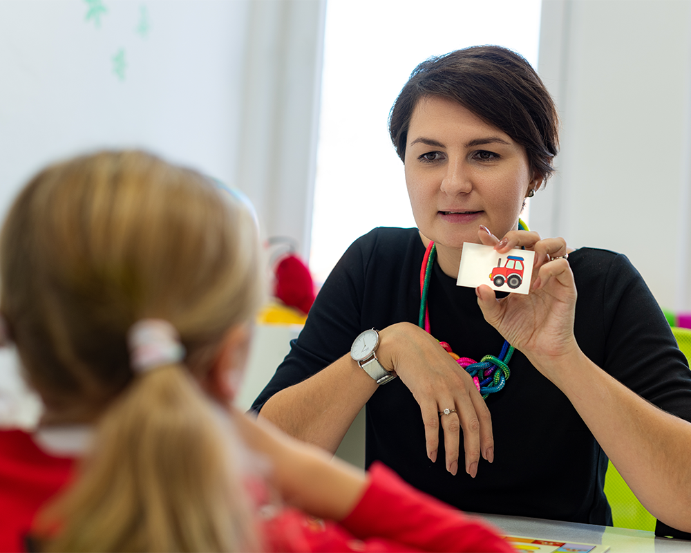 Speech and language therapist working with child with SLCN